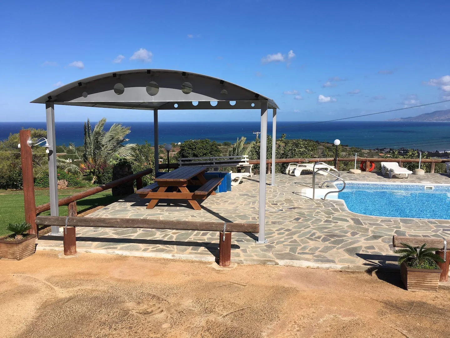 The pool terrace overlooking Chrysochous Bay from Ayia Zoni