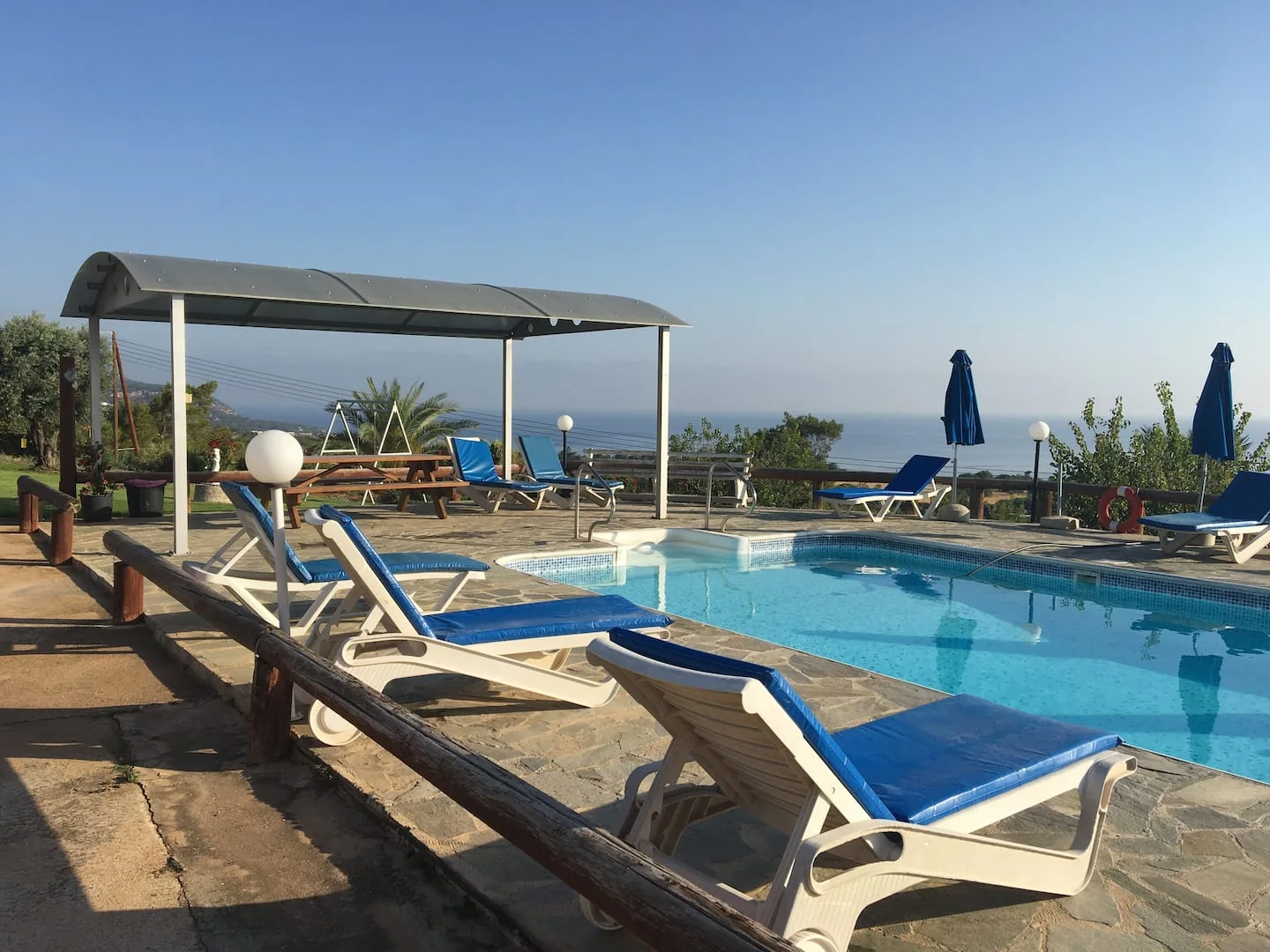 Sun loungers and the shared pool at Ayia Zoni